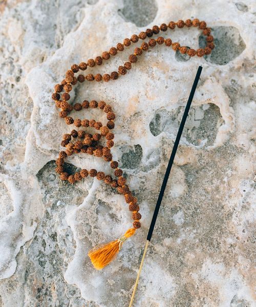 Silhouette of a person in a meditative state against a dark, quiet background.